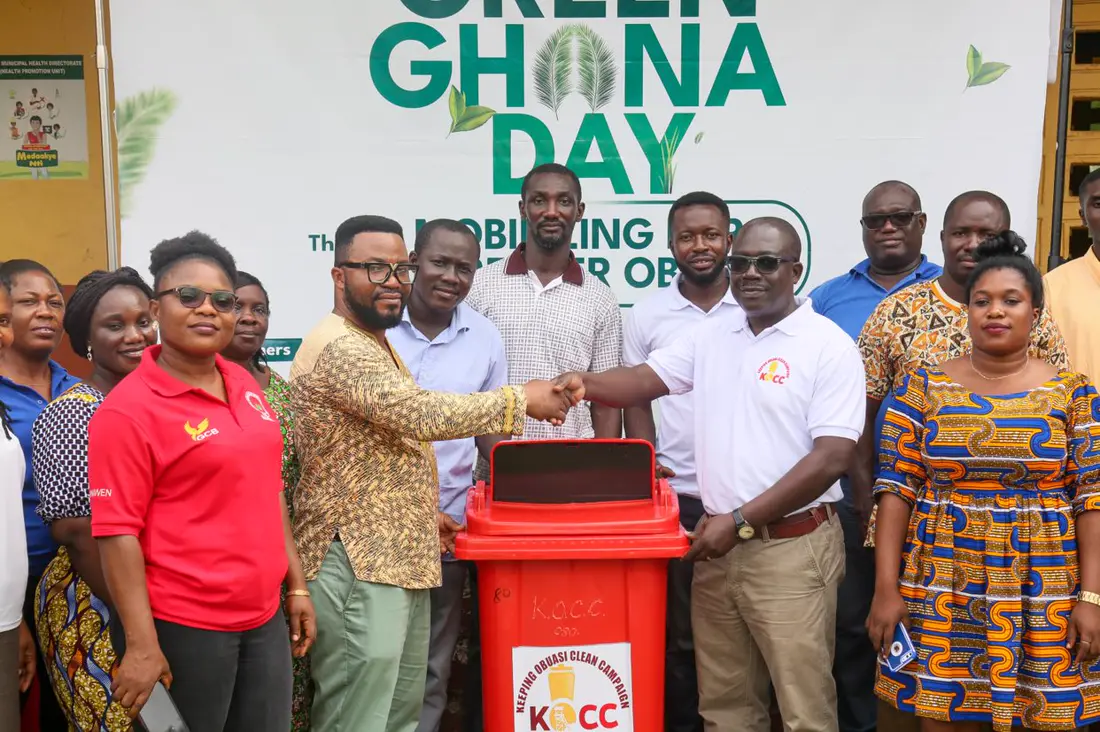 Community leaders and AGAMal staff with a waste bin at a Green Ghana Day event
